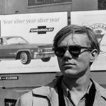 Andy in front of a Chevy billboard, spring 1965