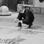 Andy spray paints the flower image, the Factory, NYC, spring 1965